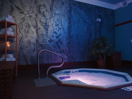 Indulge in spring break serenity with the exclusive spa jacuzzi package at The Preserve Resort and Spa, Rhode Island, nestled in a peaceful, rock-lined setting.