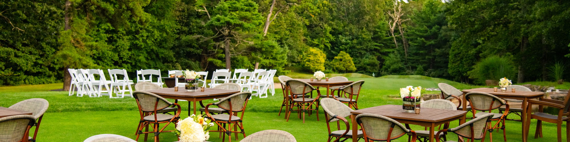 A luxury picnic setup by the tranquil waterfall garden at The Preserve Resort & Spa, an exclusive event venue.