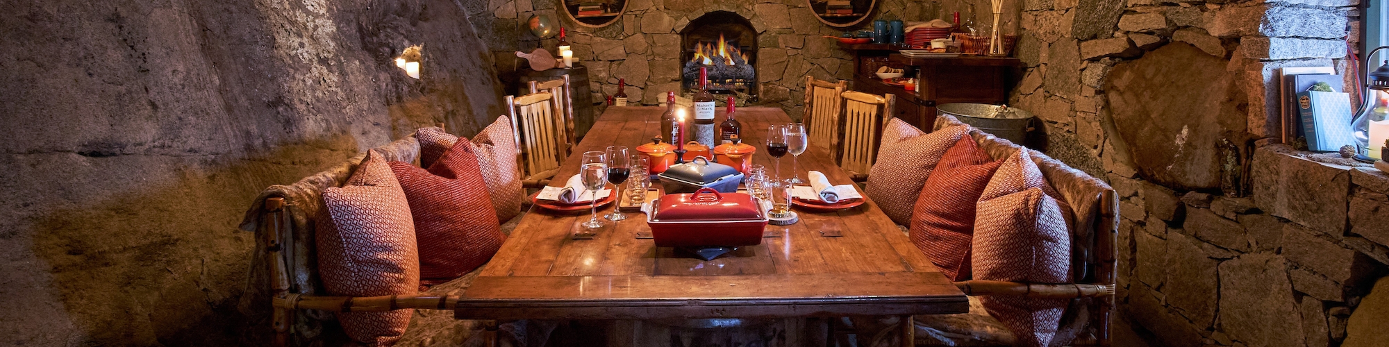 Rustic Hobbit House dining area at The Preserve Resort, RI, with a cozy fireplace and enchanting ambiance for intimate events.